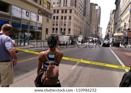 NEW YORK - AUGUST 24:  People and Media gather one block away after 2 killed and 8 injured in shooting near Empire State Building August 24, 2012  in New York City