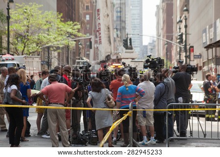 NEW YORK - MAY 31: Pedestrians, Police and Fire Department gather after an AC Unit Falls From Crane in Midtown Manhattan