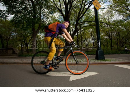 Young Man riding his bike and having fun in Central Park