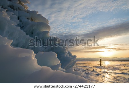People and ice mountain on the ice of lake Baikal