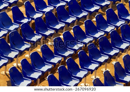 Chairs on abandoned stadium\
A few rows of old plastic chairs