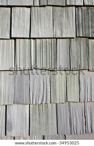 Uneven Wooden Tiles on a House Wall.