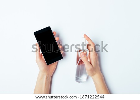 Similar – Image, Stock Photo Woman disinfecting phone with antiseptic wet wipe. Antiseptic napkin to prevent spread of germs, bacteria and coronavirus. Coronavirus prevention. Prevent illness coronavirus after public place.