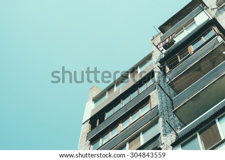 Details of a residential apartment building with balconies in a cheap area. Bottom view.