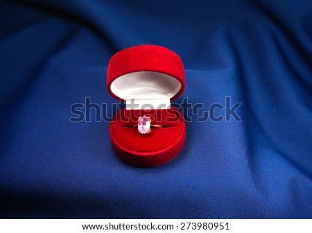 ruby ring in red box on a velvet background