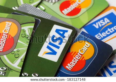 KIEV, UKRAINE - March 11: Pile of credit cards, Visa and MasterCard, credit, debit and electronic, in Kiev, Ukraine, on March 11, 2014. Selective focus.