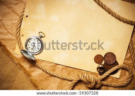 antique money with watch and rope on old yellow paper