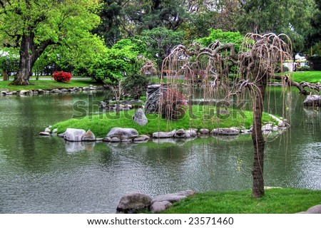 Fantasy Landscape full of green plants colorful trees stones rocks lagoon lake water fantastic dreamy shrubs grass branches leaves summer autumn spring