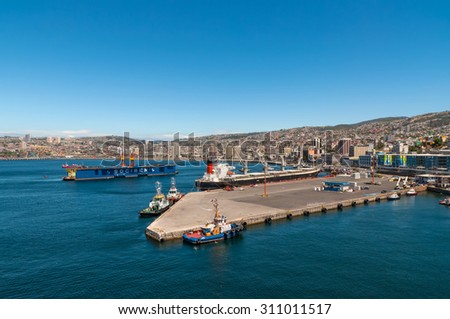 VALPARAISO, CHILE - DECEMBER 3: Panoramic view to the cargo sea port and residential area of Valparaiso city on December 3, 2012 in Valparaiso, Chile.