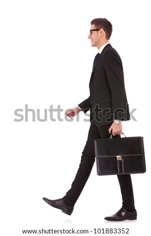 business man holding brief case and walking over white background