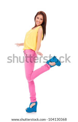 Full length portrait of happy excited casual woman with arms extended . Over white background