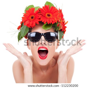 young beautiful woman wearing a gerbera wreath and sunglasses being excited about something on a white background