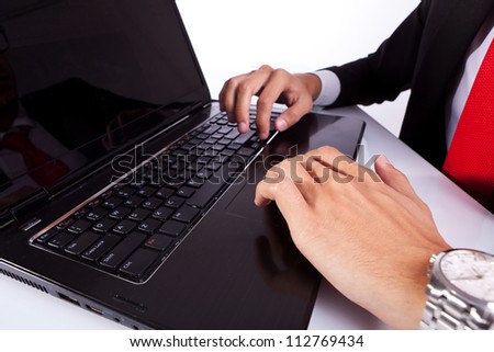 Close-up of typing male business man\'s hands on laptop