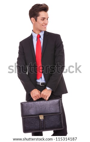 Young Business Man Holding A Briefcase And Looking To His Left Side On ...