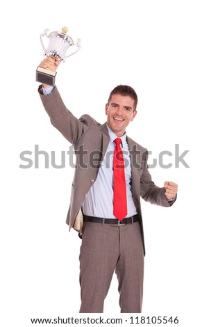 Business man cheering with winner\'s trophy on white background