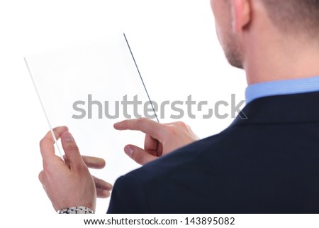 over the shoulder view of a young business man working on a futuristic transparent screen. on white background