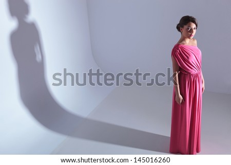 high angle full length photo of a young beauty woman looking up at the camera. on a light gray background with shadow