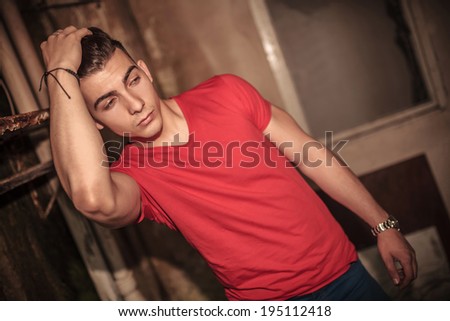 man fixing his hair and checks out something to his side
