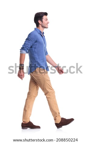 Side View Of A Smiling Young Casual Man Walking , On White Background ...