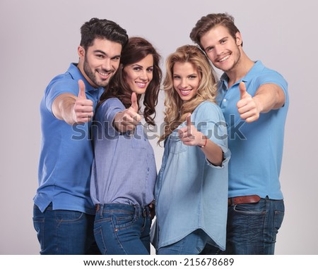 young group of casual people making the ok thumbs up hand sign on grey background