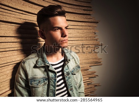 side closeup portrait of a casual man in jeans jacket looking away from the camera