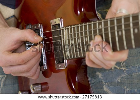 closeup of a guitar player playing his guitar