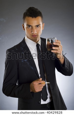 picture of a young businessman drinking and smoking