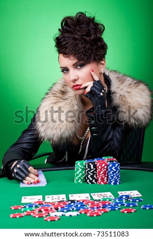 casino woman at poker table having a serious face, over green