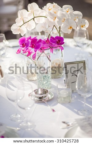 Orchid centerpiece at an outdoor event or wedding reception