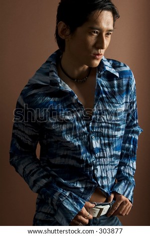 An asian male model in a patterned blue shirt