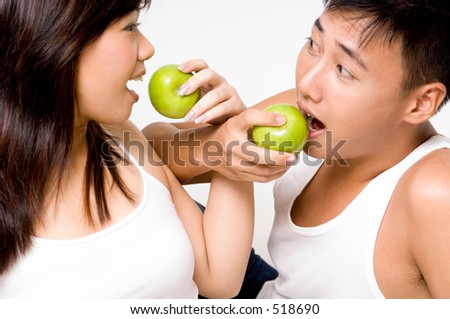 A healthy asian couple eating apples