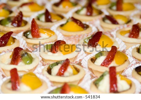 A tray full of small cakes in neat rows