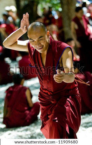 A tibetan monk holding prayer beads at the afternoon debate