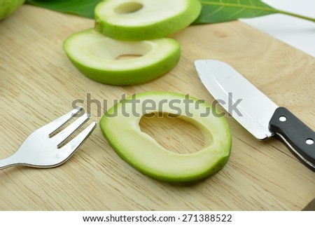 Sour mango slices on a wooden board, Mangifera indica L. Var.