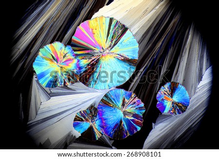 Artistic image of crystals of citric acid. These are synthetic crystals and displayed on a microscope glass slide. Photographed as seen through microscope.
