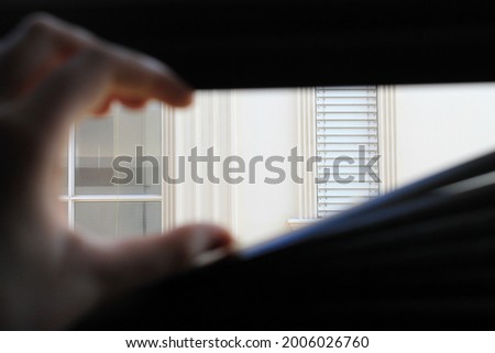 Someone stuck in a house looks outside or stalking his neighbors Stock foto © 