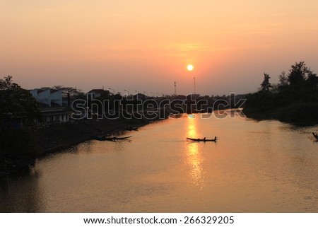The peaceful and quit life of people on the river in the sunset