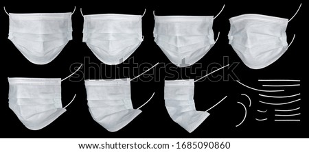 Medical mask or surgical earloop mask isolated on black background with clipping path. Large set of white medical masks on black with clipping mask. Doctor mask protects against coronovirus, close up.