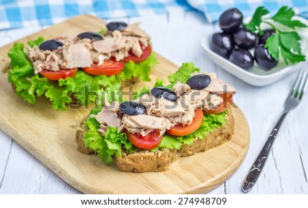Healthy sandwiches with tuna fish on the wooden board