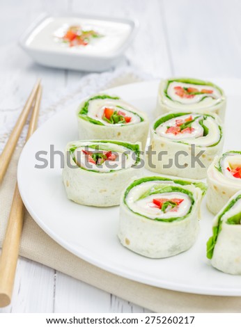 Tortilla roll with soft cheese, chicken ham, and vegetable