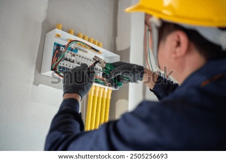 Similar – Image, Stock Photo Electrician working on the distribution panel of a house