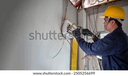Similar – Image, Stock Photo Electrician working on the distribution panel of a house