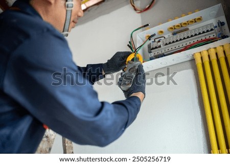 Image, Stock Photo Electrician working on the distribution panel of a house