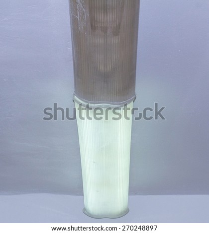 A long fluorescent lamp on the ceiling with a broken section