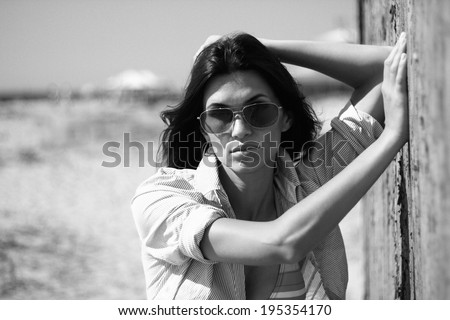 portrait of the beautiful girl in sun-protective spectacles
