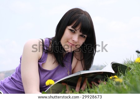 brunette rests upon herb and looks journal