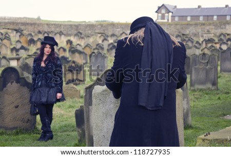 WHITBY, UK - NOV 4: A man dressed as Dracula and woman in Victorian clothing celebrating pose for a photo during the famous Goff Weekend at Whitby, England on November 4, 2012.