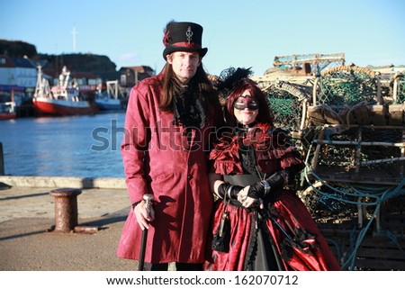 WHITBY, ENGLAND - NOVEMBER 3: Man and woman in Goths attire participating at Whitby Gothic Weekend. Whitby 3, November 2013.