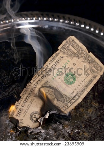 One US dollar bill, burning face up.