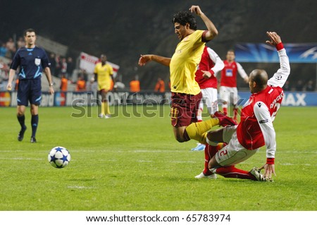 BRAGA, PORTUGAL - NOVEMBER 23: Carlos Vela (L), Arsenal (ENG) gets tackled by Alberto Rodriguez inside the penalty area at the UEFA Champions League match on November 23th, 2010 in Braga, Portugal